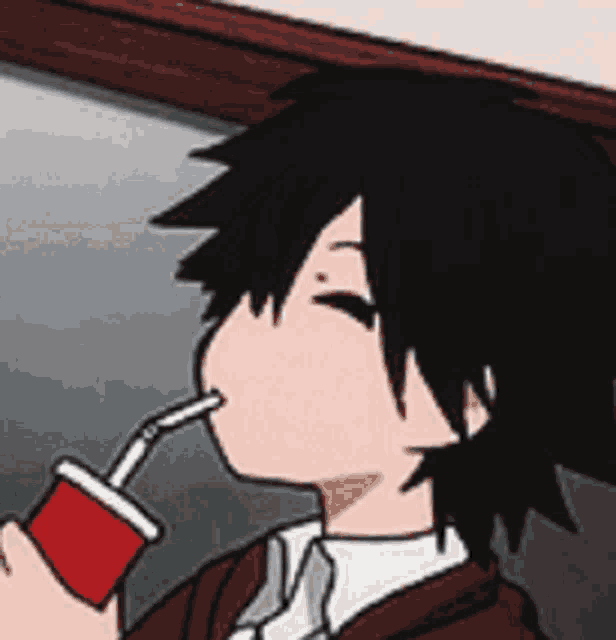 a boy in a suit and tie is drinking from a red cup with a straw .