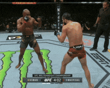 two men are fighting in a boxing ring with a monster on the ground