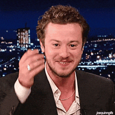 a man with a ring on his finger is smiling with the caption joequinngifs