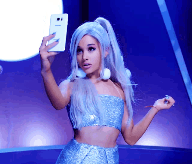 a woman taking a selfie with a phone that has the number 8 on it