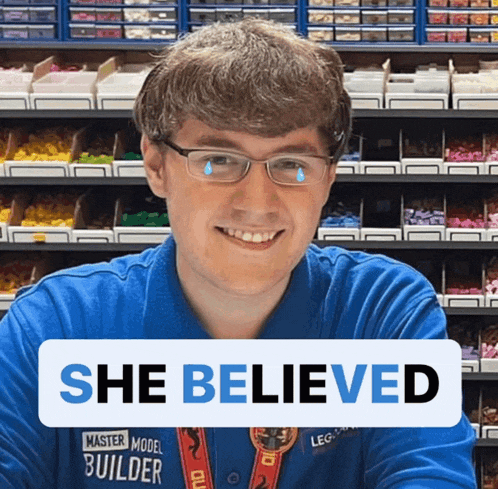 a man wearing a blue shirt that says master model builder on it