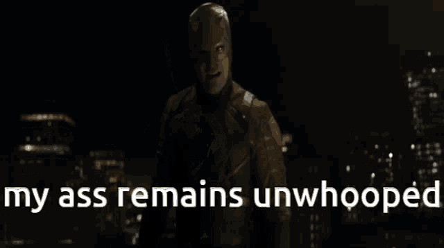a man in a superhero costume stands in the dark with the words " my ass remains unwhooped " below him