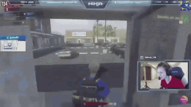 a woman is playing a video game with the name ninja on the screen
