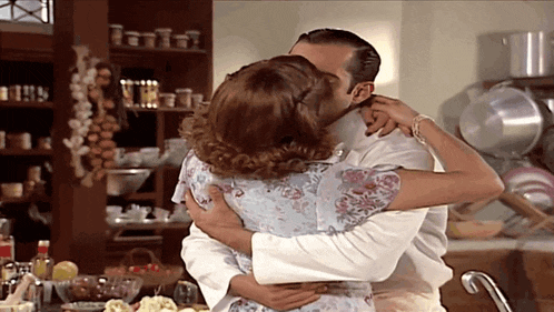 a man and a woman are hugging and kissing