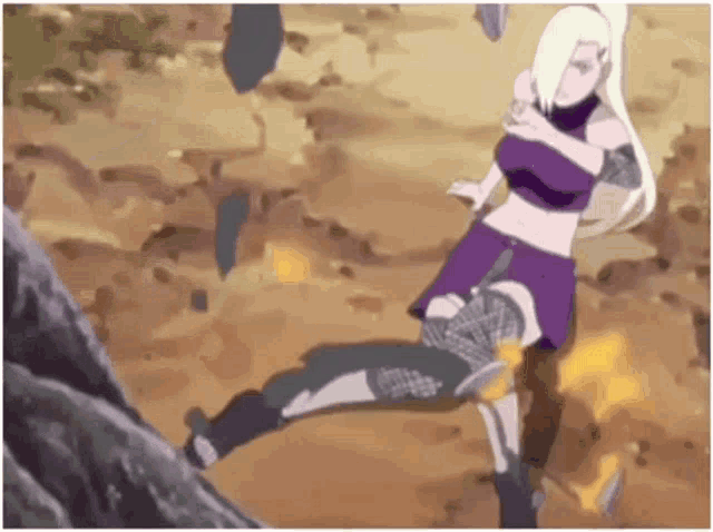 a woman in a purple dress is standing on a rock .