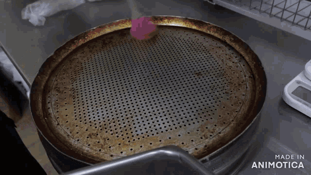 a stainless steel tray with holes in it is made in animotica