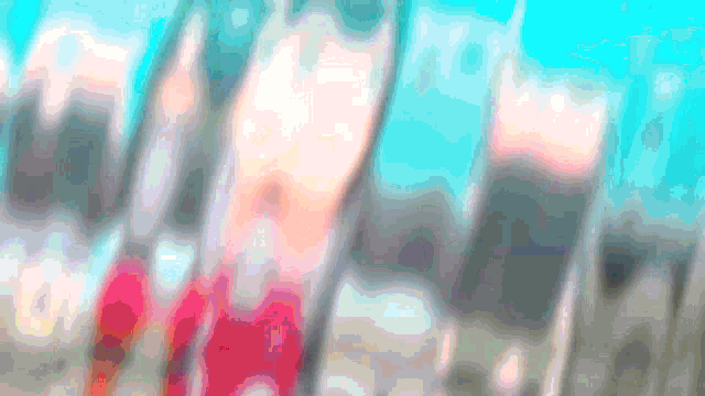 a blurred image of a person 's face with a blue sky behind them
