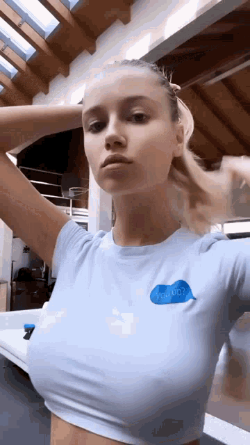 a woman wearing a blue t-shirt with a blue speech bubble that says " you do ? "