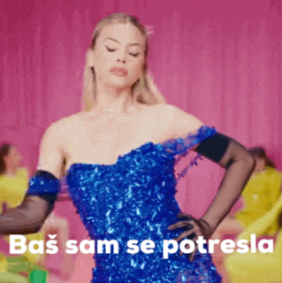 a woman in a blue dress with the words bas sam se potresla on the bottom right