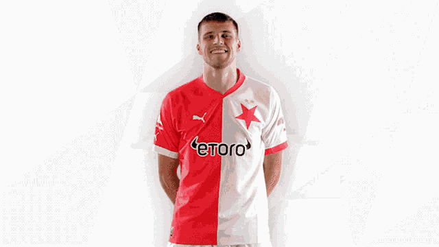 a man wearing a red and white jersey with etoro on it