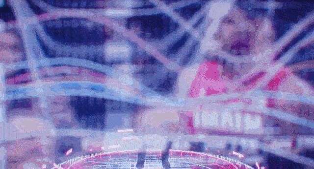 a blurry picture of a person standing in a circle with a purple background .
