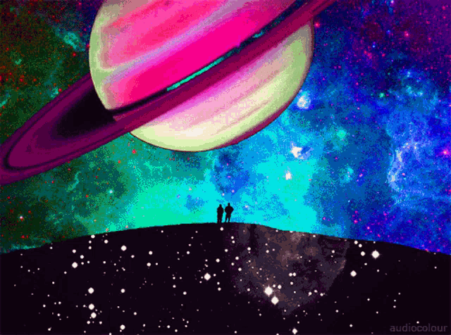 two people standing on a hill looking at a colorful planet in the sky