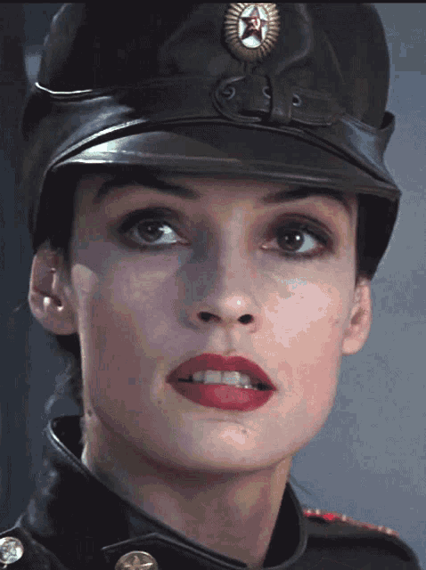 a close up of a woman wearing a military hat
