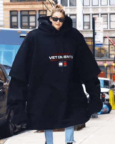 a woman wearing a hoodie that says vetements