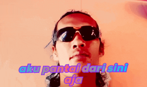 a man wearing sunglasses with the words aku pantai dari sini
