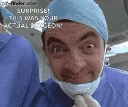 mr bean is wearing a surgical mask and a surgical cap .