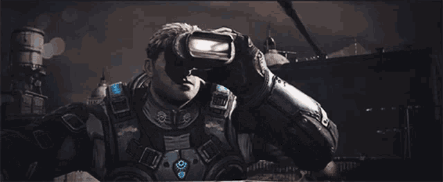 a man in a military uniform with goggles on his head is holding a gun