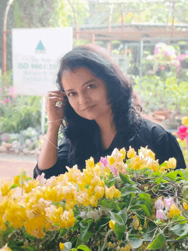 a woman stands in front of a sign that says iso 9001 2015