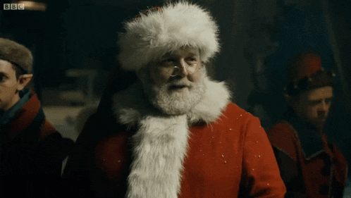a man dressed as santa claus with a bbc logo on the bottom
