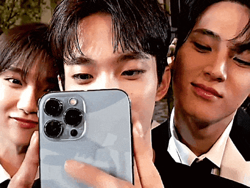 a man in a suit is taking a picture of himself with his phone