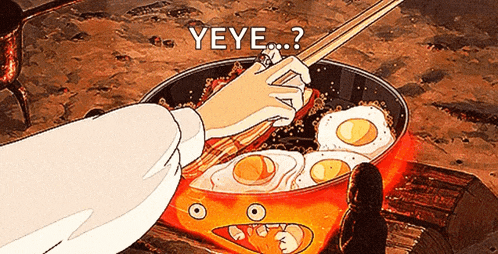 a person is cooking eggs in a frying pan with a face on it