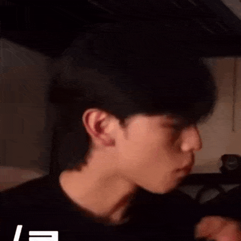 a close up of a man 's face in a dark room .