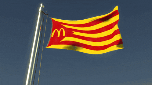 a yellow and red flag with a mcdonald 's logo on it