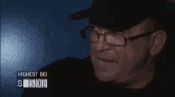 a man wearing glasses and a hat with the name dave on the bottom right