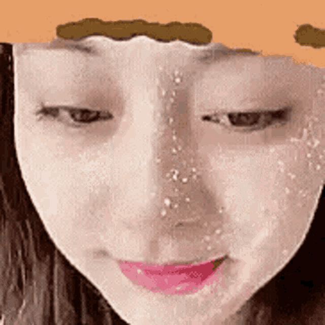 a close up of a woman 's face with a drawing of a face on it .