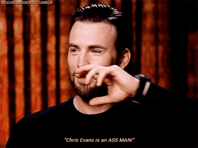 a man with a beard is making a face and says " chris evans is an ass mani "