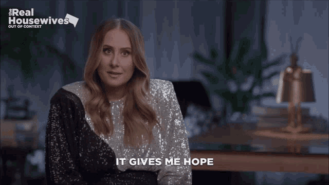 a woman says it gives me hope in front of a real housewives logo