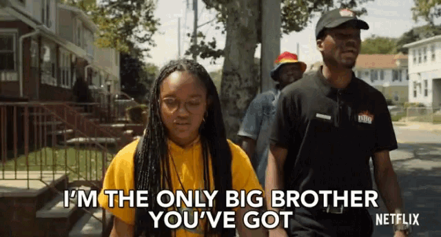 a man and a woman are walking down a street and the woman is saying i 'm the only big brother you 've got