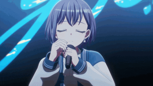 a girl is singing into a microphone in front of a blue background
