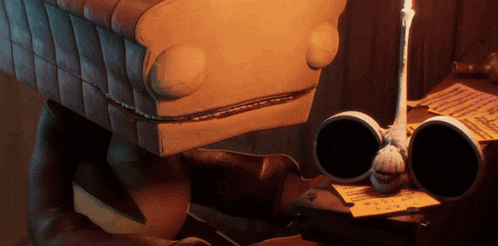a cartoon character with glasses and a candle on a desk