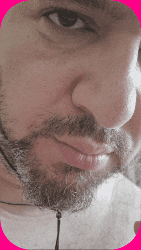 a close up of a man 's face with a pink frame around it