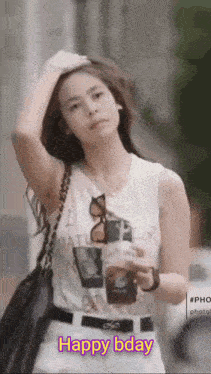 a woman in a white tank top is holding a cup of coffee with the words happy bday written on the bottom