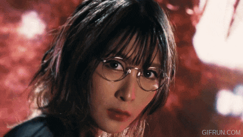 a close up of a woman wearing glasses with gifrun.com written on the bottom right