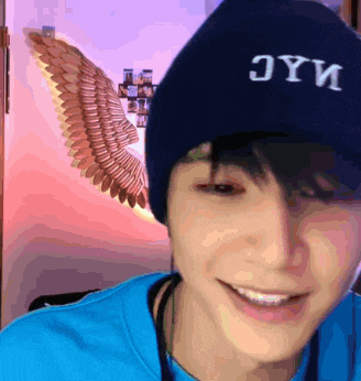a person wearing a blue hat that says jyy
