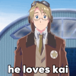 a man in a suit and tie is standing in front of an airplane and says he loves kai