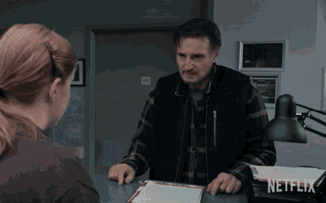 a man in a plaid shirt is talking to a woman in a netflix ad