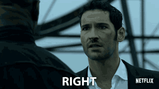 a man in a suit stands in front of a sign that says right netflix