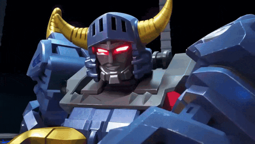 a close up of a robot with red eyes and yellow horns
