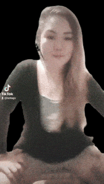 a tiktok video of a woman with long hair and a black shirt