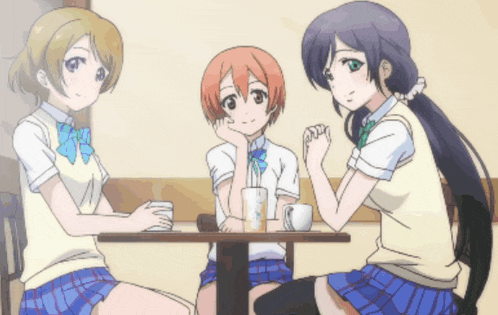 three anime girls are sitting at a table talking