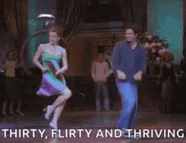 a man and a woman are dancing together in a room .