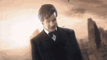 a man in a suit and tie is standing in front of a city .
