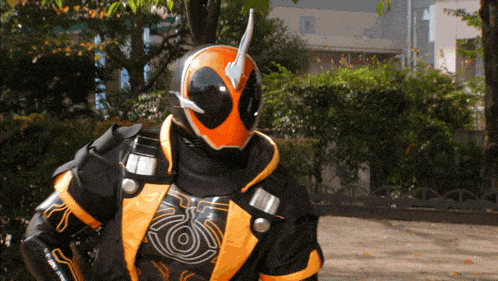 a man in a black and orange costume with a helmet