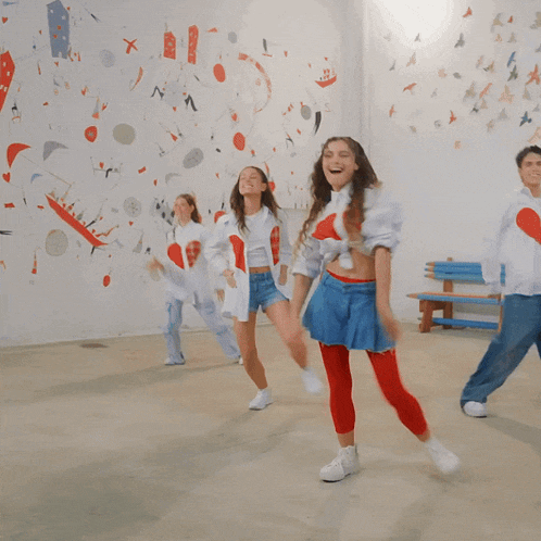 a woman in a blue skirt is dancing with a man
