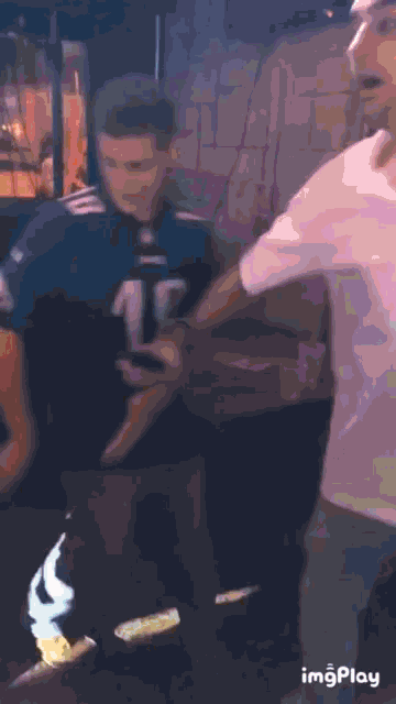 a man wearing a jersey with the number 15 on it is standing next to another man