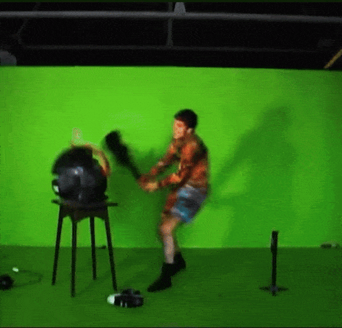 a man is standing in front of a green screen